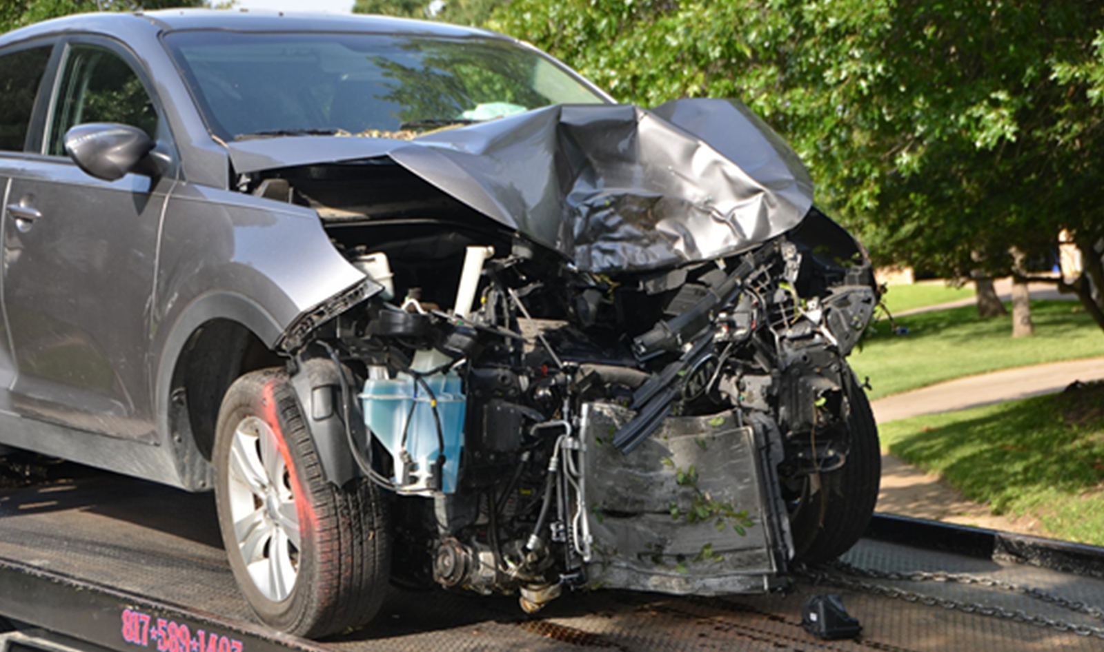 damaged car being collected from scene after a car crash