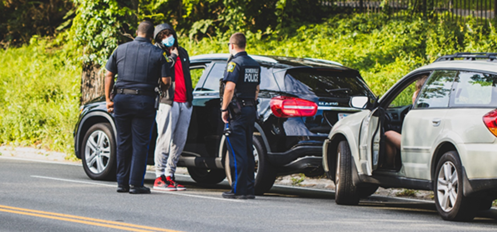 Policemen talking to a driver who was in a car accident